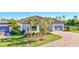 Beautiful single-story home showcasing a two-car garage, lush landscaping, and a brick driveway at 18115 Littleton Pl, Bradenton, FL 34202