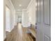Inviting hallway with wood-look tile flooring, crown molding, and a convenient bench seat near the front door at 18115 Littleton Pl, Bradenton, FL 34202