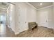 Inviting entryway featuring tiled floors, crown molding, and a wooden bench at 18115 Littleton Pl, Bradenton, FL 34202