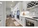 Elegant kitchen showcasing white cabinetry, stainless steel appliances, and a built-in wine fridge at 18115 Littleton Pl, Bradenton, FL 34202