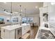Kitchen featuring white cabinets, large island, pendant lighting, stainless appliances, and an open concept layout at 18115 Littleton Pl, Bradenton, FL 34202