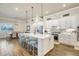 Spacious kitchen with white cabinets, large island, pendant lighting, stainless appliances, and a dining area at 18115 Littleton Pl, Bradenton, FL 34202
