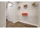 Bright laundry room with overhead shelving and plenty of space for organizing essentials at 18115 Littleton Pl, Bradenton, FL 34202