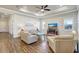 Living room with wood-look tile flooring, recessed lighting, and comfortable white leather seating at 18115 Littleton Pl, Bradenton, FL 34202