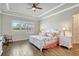 Bright and airy bedroom with tray ceilings, decorative bedding, and wood-look floors at 18115 Littleton Pl, Bradenton, FL 34202