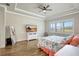 Comfortable bedroom featuring tray ceilings, wood flooring, and large windows at 18115 Littleton Pl, Bradenton, FL 34202