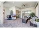 Outdoor patio featuring woven furniture, tile flooring, a grill, a television and a view of the backyard at 18115 Littleton Pl, Bradenton, FL 34202