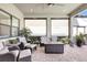 A covered outdoor patio with tile flooring, woven furniture and beautiful greenery for relaxation at 18115 Littleton Pl, Bradenton, FL 34202