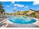 Beautiful resort-style pool with clear blue water, palm trees, lounge chairs, and a clubhouse at 18115 Littleton Pl, Bradenton, FL 34202