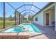Inviting in-ground pool and spa with screened enclosure and brick paver decking at 18115 Littleton Pl, Bradenton, FL 34202