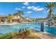 Gorgeous community pool with fountains, tropical plants, and a spacious sunbathing area, offering a resort-like experience at 18115 Littleton Pl, Bradenton, FL 34202
