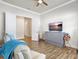 Sitting room with open double doors, tile floors, television, and two reclining chairs with blue blankets at 18115 Littleton Pl, Bradenton, FL 34202