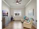 Sitting room with a ceiling fan, television, tile floors, and two reclining chairs for comfortable relaxation at 18115 Littleton Pl, Bradenton, FL 34202