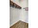 Bright walk-in closet with wood floor, wire shelving, baskets, and pink hangers offer tidy storage solutions at 18115 Littleton Pl, Bradenton, FL 34202
