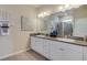 Bathroom featuring double sinks, granite countertops, and a glass-enclosed shower for a luxurious feel at 18224 Beach Ranch Ter, Lakewood Ranch, FL 34211