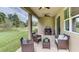 Inviting covered patio featuring comfortable seating and views of the green lawn at 18224 Beach Ranch Ter, Lakewood Ranch, FL 34211