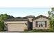 Charming single-story home with a two-car garage and stone accents, enhancing its curb appeal at 18224 Beach Ranch Ter, Lakewood Ranch, FL 34211