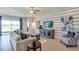 Cozy living room with comfortable seating, entertainment center, and large windows overlooking the outdoors at 18224 Beach Ranch Ter, Lakewood Ranch, FL 34211
