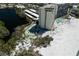 Aerial view of the condo building, beach access, and nearby lake at 20 Whispering Sands Dr # 301, Sarasota, FL 34242