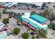 Aerial view of a vibrant blue-and-pink mixed-use building in a bustling location near Siesta Key Market at 20 Whispering Sands Dr # 301, Sarasota, FL 34242