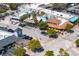 An aerial view of a picturesque coastal village with restaurants, shops, and palm trees at 20 Whispering Sands Dr # 301, Sarasota, FL 34242