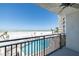 Balcony view of beach and pool, with metal railing and fan at 20 Whispering Sands Dr # 301, Sarasota, FL 34242