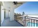 Balcony view of beach and pool, with metal railing and fan at 20 Whispering Sands Dr # 301, Sarasota, FL 34242