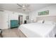 Bright bedroom features wood floors, ensuite bath, and stylish decor at 20 Whispering Sands Dr # 301, Sarasota, FL 34242