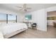 Unwind in this well lit bedroom with coastal views from the private balcony at 20 Whispering Sands Dr # 301, Sarasota, FL 34242