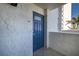 Exterior view of front door, number 301, and stucco siding at 20 Whispering Sands Dr # 301, Sarasota, FL 34242
