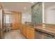 Modern kitchen boasts granite counters, wood cabinets, stainless steel appliances and decorative tile backsplash at 20 Whispering Sands Dr # 301, Sarasota, FL 34242