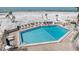Large community pool surrounded by lounge chairs with beach views at 20 Whispering Sands Dr # 301, Sarasota, FL 34242