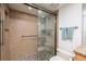 Bathroom features glass shower, pebble floor, and light tan tile at 20 Whispering Sands Dr # 301, Sarasota, FL 34242