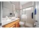 Well-lit bathroom featuring a glass-enclosed shower, vanity and a neutral tiling at 2114 147Th E Ct, Bradenton, FL 34212