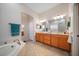 Spa-like bathroom features a soaking tub, double vanity, and a separate shower for ultimate relaxation at 2114 147Th E Ct, Bradenton, FL 34212