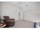 Bedroom featuring a recliner, ceiling fan, closet and carpet flooring at 2114 147Th E Ct, Bradenton, FL 34212