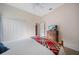 Bedroom featuring a bed with a plaid blanket, ceiling fan, and spacious closet at 2114 147Th E Ct, Bradenton, FL 34212