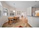 Bright dining area features wood-look tile, modern light fixture, and views into other rooms at 2114 147Th E Ct, Bradenton, FL 34212