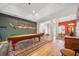 Spacious game room with a pool table, wood floors, and decorative vintage sporting equipment on the walls at 2114 147Th E Ct, Bradenton, FL 34212