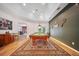 An expansive game room featuring a pool table beneath a vaulted ceiling, complemented by rustic decor on the far wall at 2114 147Th E Ct, Bradenton, FL 34212