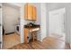 Functional hallway nook with built-in cabinets, granite counters, wine storage, and access to the laundry room at 2114 147Th E Ct, Bradenton, FL 34212
