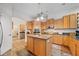 Bright, spacious kitchen with island, wooden cabinets, modern appliances and seamless flow to other areas at 2114 147Th E Ct, Bradenton, FL 34212