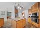 Open kitchen features wooden cabinets, an island, granite countertops and stainless steel appliances at 2114 147Th E Ct, Bradenton, FL 34212