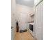 Well-lit laundry room with washer, dryer, storage shelves, and easy access from hallway and other rooms at 2114 147Th E Ct, Bradenton, FL 34212