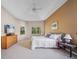 Inviting main bedroom with tray ceilings, large windows, carpeted floor, and neutral wall paint at 2114 147Th E Ct, Bradenton, FL 34212