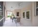Inviting screened porch features a ceiling fan and furniture perfect for relaxation and outdoor dining at 2114 147Th E Ct, Bradenton, FL 34212