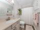 Bathroom featuring a vanity with modern fixtures, elegant decor, and white shower curtain at 2160 Chenille Ct, Venice, FL 34292