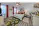 Comfortable bedroom with orange accents, shiplap wall, and stylish decor and neutral walls at 2160 Chenille Ct, Venice, FL 34292