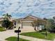 Beautiful single-story home featuring a paver driveway, manicured lawn and mature trees at 2160 Chenille Ct, Venice, FL 34292