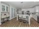 Bright eat-in kitchen featuring white cabinets, a large island with seating, and stainless steel appliances at 2160 Chenille Ct, Venice, FL 34292
